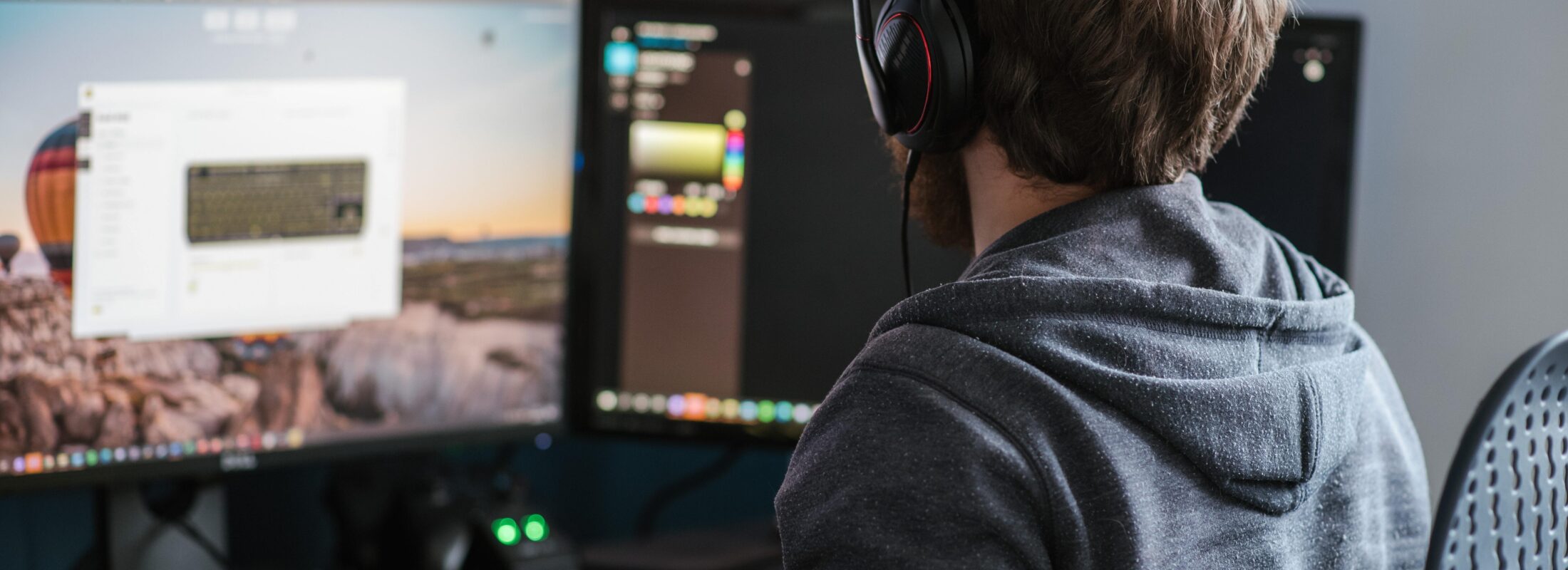 Guy behind computer with headphones