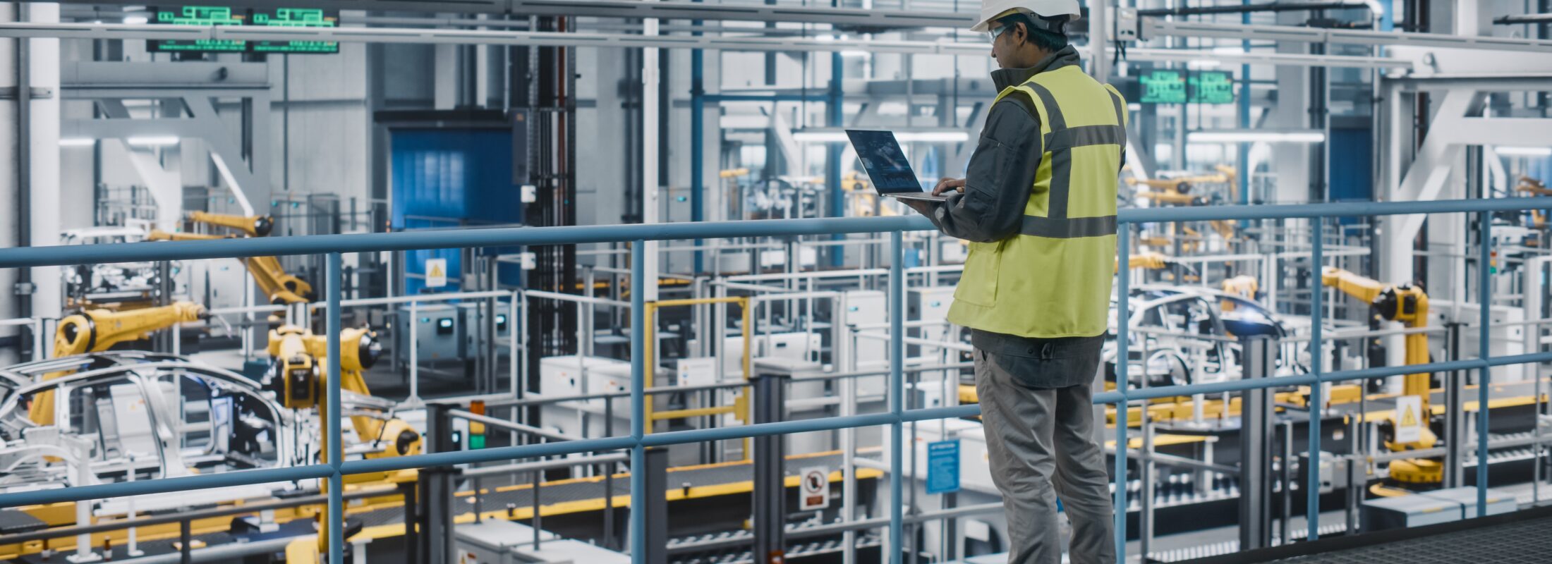 Man with computer at production site